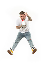 Image showing Jumping fan on white background. The young man as soccer football fan with megaphone