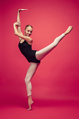 Image showing Young teen dancer on red studio background.
