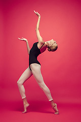 Image showing Young teen dancer on red studio background.