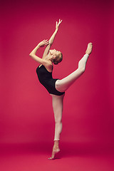 Image showing Young teen dancer on red studio background.