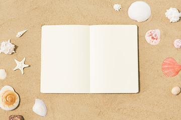 Image showing notebook with seashells on beach sand