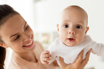 Image showing happy mother playing with little baby boy at home