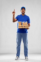 Image showing happy indian delivery man with food and drinks