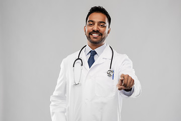 Image showing smiling indian male doctor pointing finger to you