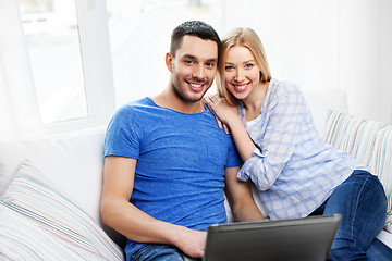 Image showing happy couple with laptop computer at home