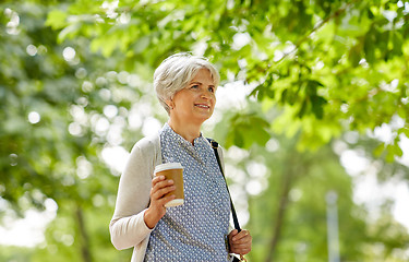 Image showing senior woman drinking takeaway coffee at park