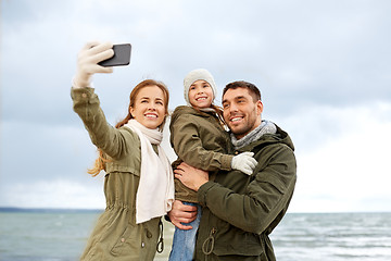 Image showing family taking selfie by smartphone on autumn beach