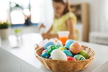 Image showing colored easter eggs and girl on background at home
