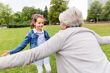 Image showing grandmother and granddaughter playing at park