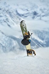 Image showing Snowboard high up in the snowy Alps