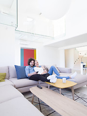 Image showing Young couple on the sofa watching television