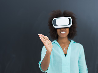 Image showing black girl using VR headset isolated on gray background