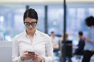 Image showing Elegant Woman Using Mobile Phone in startup office building