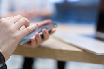 Image showing Elegant Woman Using Mobile Phone in startup office building