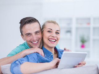 Image showing couple relaxing at  home with tablet computers