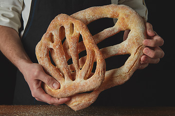 Image showing Baker is holding fougas bread