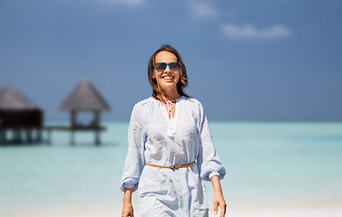Image showing happy woman over tropical beach and bungalow
