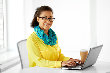 Image showing creative woman with laptop and coffee at office