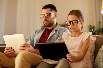 Image showing father and daughter with tablet computers at home