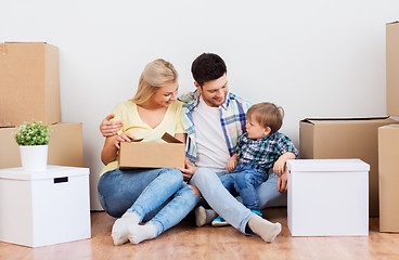 Image showing happy family with boxes moving to new home