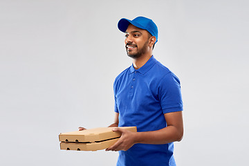 Image showing happy indian delivery man with pizza boxes in blue