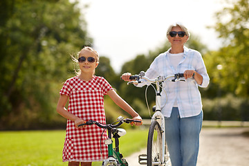 Image showing grandmother and granddaughter with bicycles