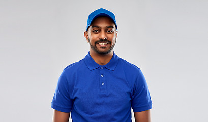 Image showing happy indian delivery man in blue uniform