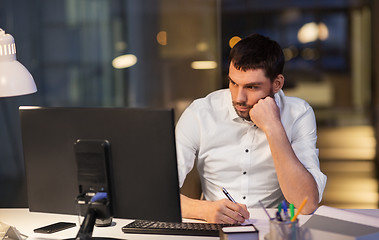 Image showing businessman with computer working at night office