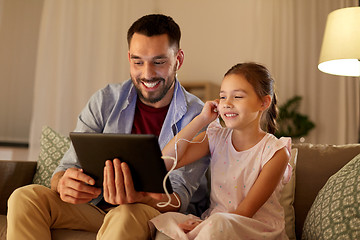 Image showing father and daughter listening to music on tablet