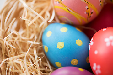 Image showing close up of colored easter eggs in straw