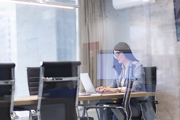 Image showing businesswoman using a laptop in startup office