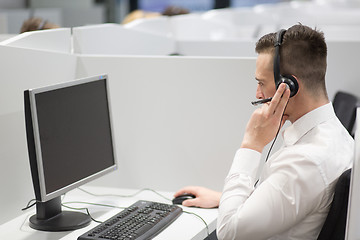 Image showing male call centre operator doing his job