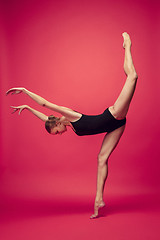 Image showing Young teen dancer on red studio background.