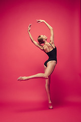 Image showing Young teen dancer on red studio background.