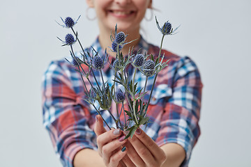 Image showing Young girl holding a blue flower