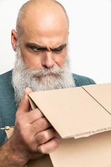 Image showing skeptical looking bearded man with a carton box