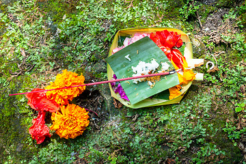 Image showing Votive offering with flowers, cookies and ribbons