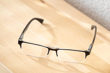 Image showing reading glasses on a wooden table