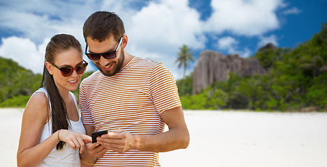 Image showing happy couple with smartphone on seychelles island