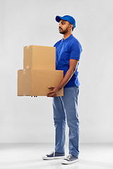 Image showing indian delivery man with parcel boxes in blue