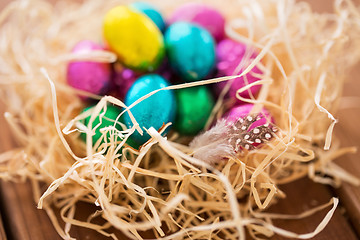 Image showing chocolate easter eggs in straw nest on table