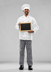 Image showing happy male indian chef in toque with chalkboard