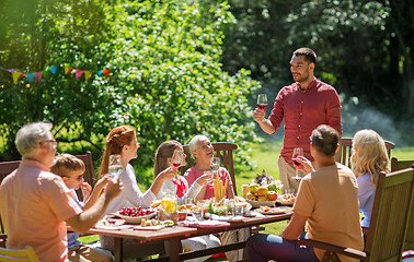 Image showing happy family having dinner or summer garden party