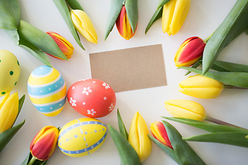 Image showing close up of colored easter eggs and tulip flowers