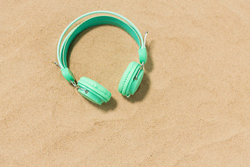 Image showing earphones on summer beach sand