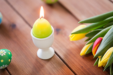 Image showing candle in shape of easter egg and tulip flowers