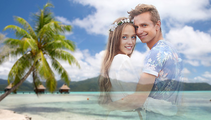 Image showing hippie couple fading over exotic beach background