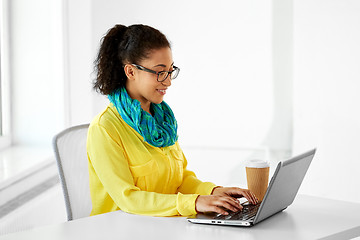 Image showing creative woman with laptop and coffee at office