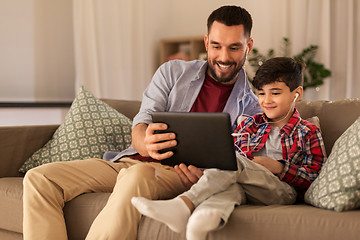 Image showing father and son listening to music on tablet pc