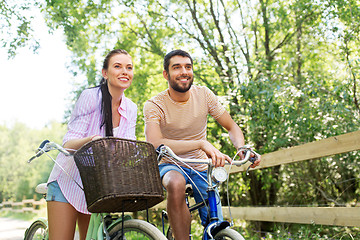 Image showing happy couple with bicycles at summer park